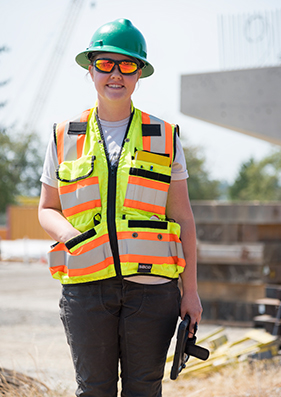 Hanna Elder at a construction site holding an ipad